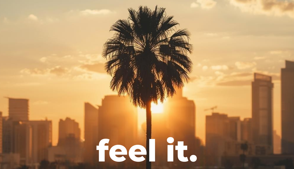 feel it. logo over a palm tree and city skyline at sunset, unisex fleece jogger sets from Melbourne